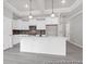 Open kitchen boasts stainless appliances, white cabinetry, and a large center island at 1056 Marsh Harrier Dr # Cc3-15-6P, Ravenel, SC 29470