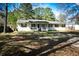 Well-maintained single-story home with a front porch and mature trees at 106 Harriet Tubman Ln, Moncks Corner, SC 29461