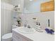 Well-lit bathroom featuring a classic white sink, decorative floral wallpaper, and essential toiletries at 1060 Yeamans Hall Rd, Hanahan, SC 29410