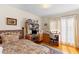 Comfortable bedroom with a bed, wooden desk, and bright natural light at 1060 Yeamans Hall Rd, Hanahan, SC 29410