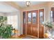 Inviting entryway with a stained wood door featuring glass panels, hardwood floors, and stylish decor at 1060 Yeamans Hall Rd, Hanahan, SC 29410