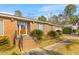Charming single-story brick home with a well-manicured lawn and mature landscaping at 1060 Yeamans Hall Rd, Hanahan, SC 29410