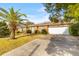 Classic brick home featuring an attached two-car garage and mature palm tree at 1060 Yeamans Hall Rd, Hanahan, SC 29410