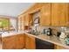 Well-lit kitchen featuring wooden cabinets, white countertops, and stainless steel sink at 1060 Yeamans Hall Rd, Hanahan, SC 29410