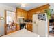 Classic kitchen with wood cabinets, appliances, and a view into a light-filled dining area at 1060 Yeamans Hall Rd, Hanahan, SC 29410