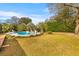 Backyard inground pool surrounded by lush palm trees and lounge chairs at 1060 Yeamans Hall Rd, Hanahan, SC 29410