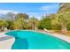 Inviting backyard pool area surrounded by lush landscaping and comfortable lounge chairs at 1060 Yeamans Hall Rd, Hanahan, SC 29410