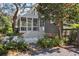 Backyard featuring a screened porch, upper deck, and landscaped yard with flowering bushes at 118 Freeman St, Mount Pleasant, SC 29464