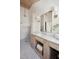 Bright bathroom with tile shower, marble countertops, wooden vanity, and sconce lighting at 118 Freeman St, Mount Pleasant, SC 29464