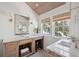 Bright bathroom with marble countertops, wood ceiling, and wooden vanity at 118 Freeman St, Mount Pleasant, SC 29464