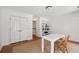 Bedroom features hardwood floors, white walls, and white table with a brown chair at 118 Freeman St, Mount Pleasant, SC 29464