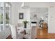 This dining room has a marble table, seating for four, and flows into the living room with a fireplace at 118 Freeman St, Mount Pleasant, SC 29464
