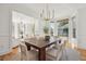 Elegant dining room featuring a wooden table, woven chairs, and large windows with a view of the outdoors at 118 Freeman St, Mount Pleasant, SC 29464