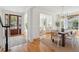 Open dining room with a wooden table, white chairs, and views into the foyer and living spaces at 118 Freeman St, Mount Pleasant, SC 29464