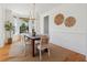 Cozy dining room with natural light, wooden table, woven chairs, and unique decorative wall pieces at 118 Freeman St, Mount Pleasant, SC 29464