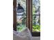 Close up of stylish door with brass handles and a window overlooking the garden at 118 Freeman St, Mount Pleasant, SC 29464