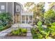Charming home featuring a welcoming front porch, upper deck, and professionally landscaped yard with stone pavers at 118 Freeman St, Mount Pleasant, SC 29464
