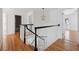 Bright hallway with wood floors and black and white railings at 118 Freeman St, Mount Pleasant, SC 29464