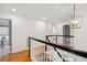 Bright hallway with wood floors, white walls, and a decorative gold light fixture at 118 Freeman St, Mount Pleasant, SC 29464