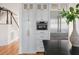 Kitchen wall featuring stainless steel appliances, custom cabinets, and a view of the foyer and stairway at 118 Freeman St, Mount Pleasant, SC 29464