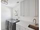 Laundry room featuring modern washer/dryer, white cabinets, and quartz countertop at 118 Freeman St, Mount Pleasant, SC 29464