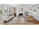 Bright living room featuring a fireplace, hardwood floors, built-in bookshelves and a large window for natural light at 118 Freeman St, Mount Pleasant, SC 29464