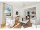 Open-concept living room with white sofas, a gold and marble coffee table, and views into the dining area at 118 Freeman St, Mount Pleasant, SC 29464