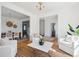 Stylish living room offering white seating, hardwood floors, and a view into the dining area and front foyer at 118 Freeman St, Mount Pleasant, SC 29464