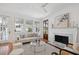 Bright living room featuring a fireplace, hardwood floors, a large window for natural light, and a view of the outside at 118 Freeman St, Mount Pleasant, SC 29464