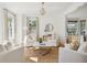 Inviting living room featuring white armchairs, a marble coffee table, jute rug and abundant natural light at 118 Freeman St, Mount Pleasant, SC 29464