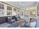 Inviting screened porch with comfortable seating and views of the surrounding greenery at 118 Freeman St, Mount Pleasant, SC 29464