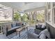 Relaxing screened porch with comfortable seating and views of the surrounding greenery at 118 Freeman St, Mount Pleasant, SC 29464