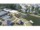 A scenic aerial view of a lakefront community featuring tennis courts and a pier at 125 Leeward Landing, Summerville, SC 29486