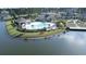 Aerial image of large lakefront community pool with palm trees, seating, and well-maintained landscaping at 125 Leeward Landing, Summerville, SC 29486