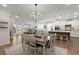Open floor plan showcases the dining area with a stylish chandelier, seamlessly connecting to the kitchen and living room at 125 Leeward Landing, Summerville, SC 29486