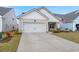 Charming single-story home with a two-car garage, manicured lawn, and inviting curb appeal at 125 Leeward Landing, Summerville, SC 29486