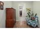 Hallway with wood floors that connects rooms with a view of a large wooden dresser and seating chair at 125 Leeward Landing, Summerville, SC 29486