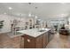 Open kitchen with island, dining space, and living area, creating a spacious and inviting atmosphere at 125 Leeward Landing, Summerville, SC 29486
