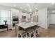 A modern kitchen with stainless steel appliances, white cabinets, and a large center island with barstool seating at 125 Leeward Landing, Summerville, SC 29486
