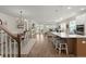 Open-concept living space with kitchen island, dining area, fireplace, and access to outdoor area at 125 Leeward Landing, Summerville, SC 29486