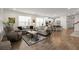 Bright living room flows into open kitchen with modern appliances and a cozy breakfast bar at 125 Leeward Landing, Summerville, SC 29486