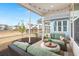 Relaxing screened porch with comfortable seating and decorative string lights at 125 Leeward Landing, Summerville, SC 29486