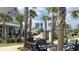 Outdoor lounge area showcasing palm trees, comfortable seating, and a relaxing fireplace at 125 Leeward Landing, Summerville, SC 29486