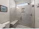 Modern walk-in shower with frameless glass door, bench, tile surround and recessed lights at 125 Leeward Landing, Summerville, SC 29486