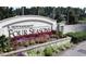 Entrance sign for K. Hovnanian's Four Seasons community with lush landscaping and colorful flowers at 125 Leeward Landing, Summerville, SC 29486