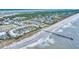 Panoramic aerial view of a beachfront resort featuring a long fishing pier and oceanfront pool at 1300 Ocean Blvd # 232, Isle of Palms, SC 29451