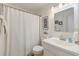 Well-lit bathroom with white vanity, mirror, and shower with starfish wall decor at 1300 Ocean Blvd # 232, Isle of Palms, SC 29451