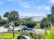 Scenic view with tropical landscaping of a parking area and the beach pier in the background at 1300 Ocean Blvd # 232, Isle of Palms, SC 29451