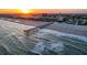 Scenic sunset view of the ocean waves, beach, and pier from the condo community at 1300 Ocean Blvd # 232, Isle of Palms, SC 29451