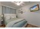 Cozy bedroom with a ceiling fan, TV, and soothing color scheme for a relaxing atmosphere at 1300 Ocean Blvd # 232, Isle of Palms, SC 29451